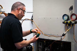 A Southeast Scientific service technician testing laboratory equipment.