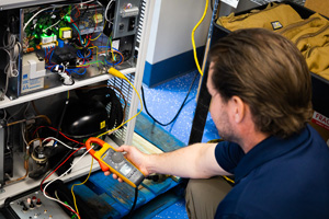 Southeast Scientific service technicians repairing laboratory equipment.