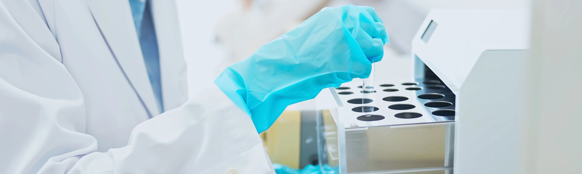 Two women in a scientific laboratory hording equipment 